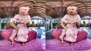 Solo performer with a toy on rumpled bedsheets