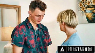 Couple mid-scene in a dim bedroom