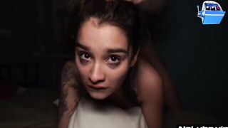 Couple mid-scene in a dim bedroom