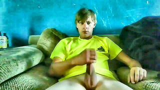 Solo performer with a toy on rumpled bedsheets
