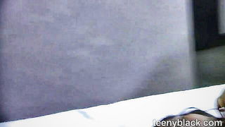 Couple on a made bed in an explicit scene