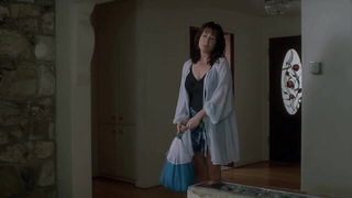 Couple mid-scene in a dim bedroom