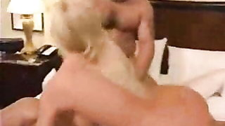 Explicit massage scene in a softly lit room