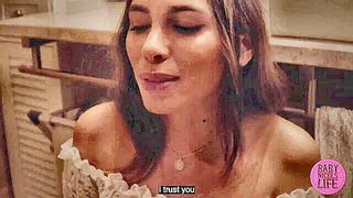Solo performer with a toy on rumpled bedsheets