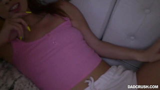 Amateur couple on a living room sofa in explicit scene