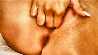 Couple on a made bed in an explicit scene