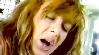 Explicit massage scene in a softly lit room
