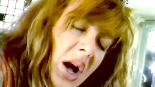Explicit massage scene in a softly lit room