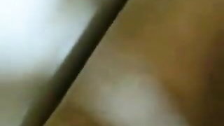 Amateur couple on a living room sofa in explicit scene