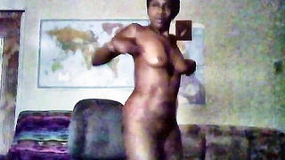 Solo performer with a toy on rumpled bedsheets