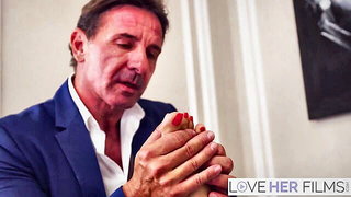 Explicit massage scene in a softly lit room