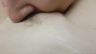 Couple on a patterned bedspread in an explicit scene