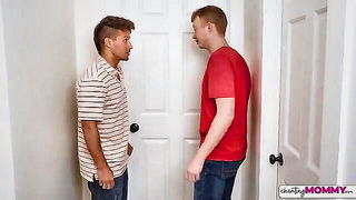 Couple mid-scene in a dim bedroom