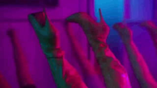 Couple mid-scene in a dim bedroom