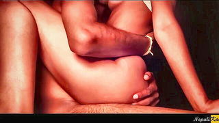 Amateur couple on a living room sofa in explicit scene