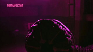 Couple mid-scene in a dim bedroom