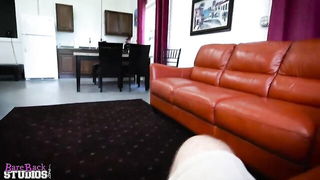 Couple on a made bed in an explicit scene