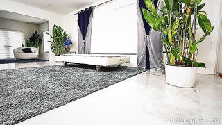 Amateur couple on a living room sofa in explicit scene