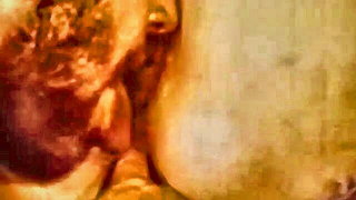 Explicit massage scene in a softly lit room
