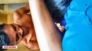 Couple on a made bed in an explicit scene
