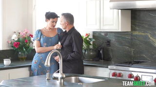 Couple on a patterned bedspread in an explicit scene