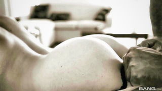 Amateur couple on a living room sofa in explicit scene
