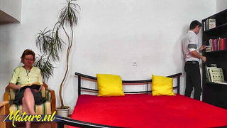 Couple mid-scene in a dim bedroom