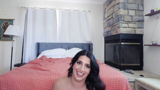 Couple on a made bed in an explicit scene