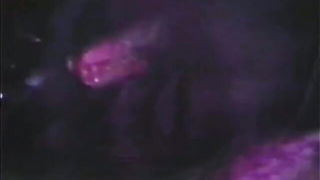 Couple mid-scene in a dim bedroom