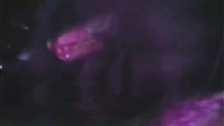 Couple mid-scene in a dim bedroom