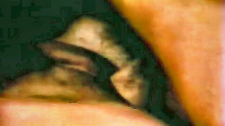 Amateur couple on a living room sofa in explicit scene