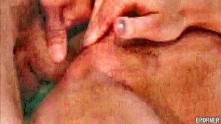 Amateur couple on a living room sofa in explicit scene