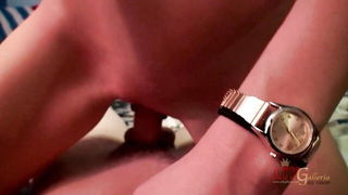 Couple on a patterned bedspread in an explicit scene