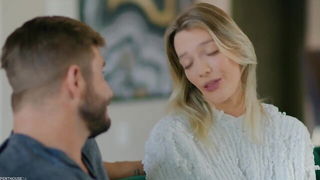 Couple on a patterned bedspread in an explicit scene