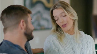Couple on a patterned bedspread in an explicit scene