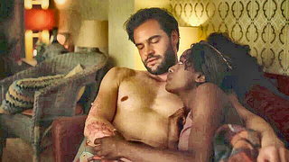 Couple on a made bed in an explicit scene