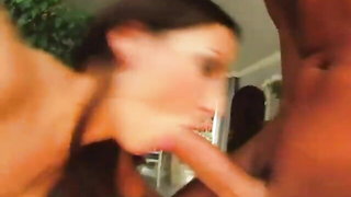 Couple on a made bed in an explicit scene