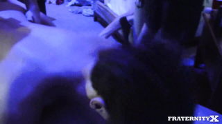 Solo performer with a toy on rumpled bedsheets
