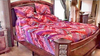 Amateur couple on a living room sofa in explicit scene