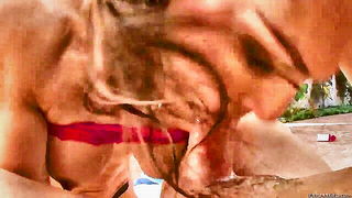 Couple on a made bed in an explicit scene
