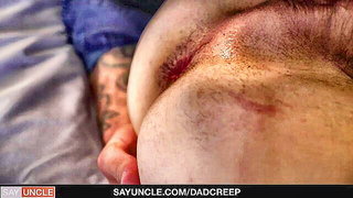 Couple on a patterned bedspread in an explicit scene