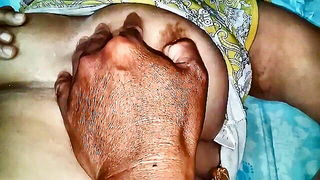 Couple on a made bed in an explicit scene