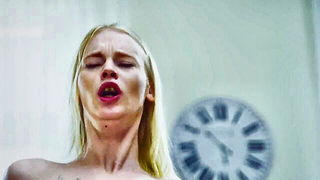 Solo performer with a toy on rumpled bedsheets
