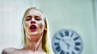 Solo performer with a toy on rumpled bedsheets