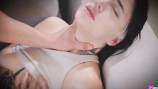 Couple on a patterned bedspread in an explicit scene