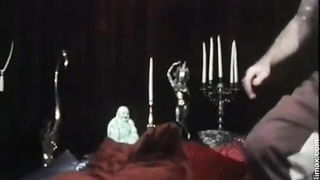 Solo performer with a toy on rumpled bedsheets
