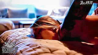 Couple on a made bed in an explicit scene