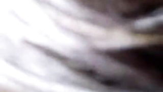 Couple on a made bed in an explicit scene