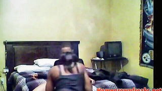Amateur couple on a living room sofa in explicit scene