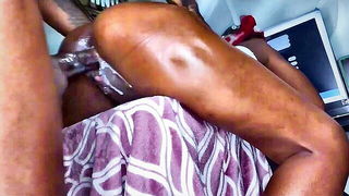 Amateur couple on a living room sofa in explicit scene